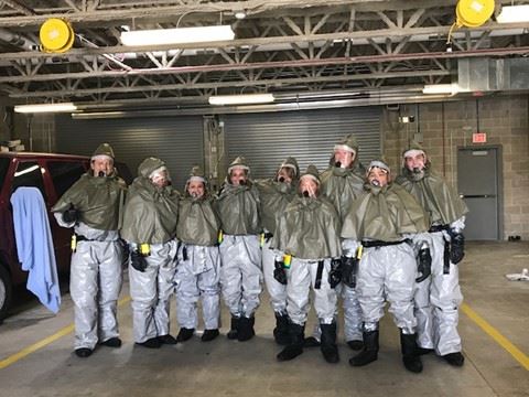 Staff in hazmat suits